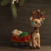Reindeer with a sleigh a bag for gifts and Christmas tree