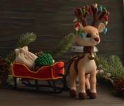 Reindeer with a sleigh a bag for gifts and Christmas tree